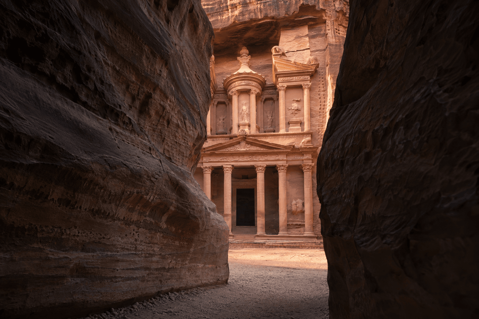 Petra’s Treasury framed by the sandstone walls of the Siq